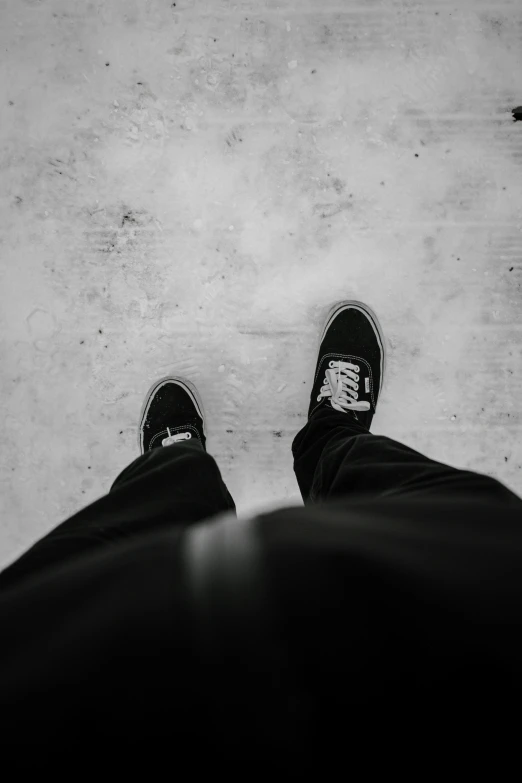 black and white pograph of person's shoes and feet