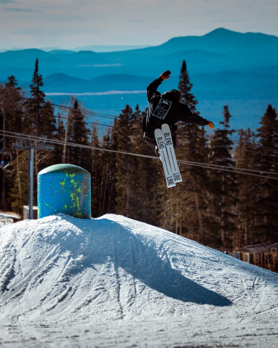 a snowboarder performing a jump on a hill