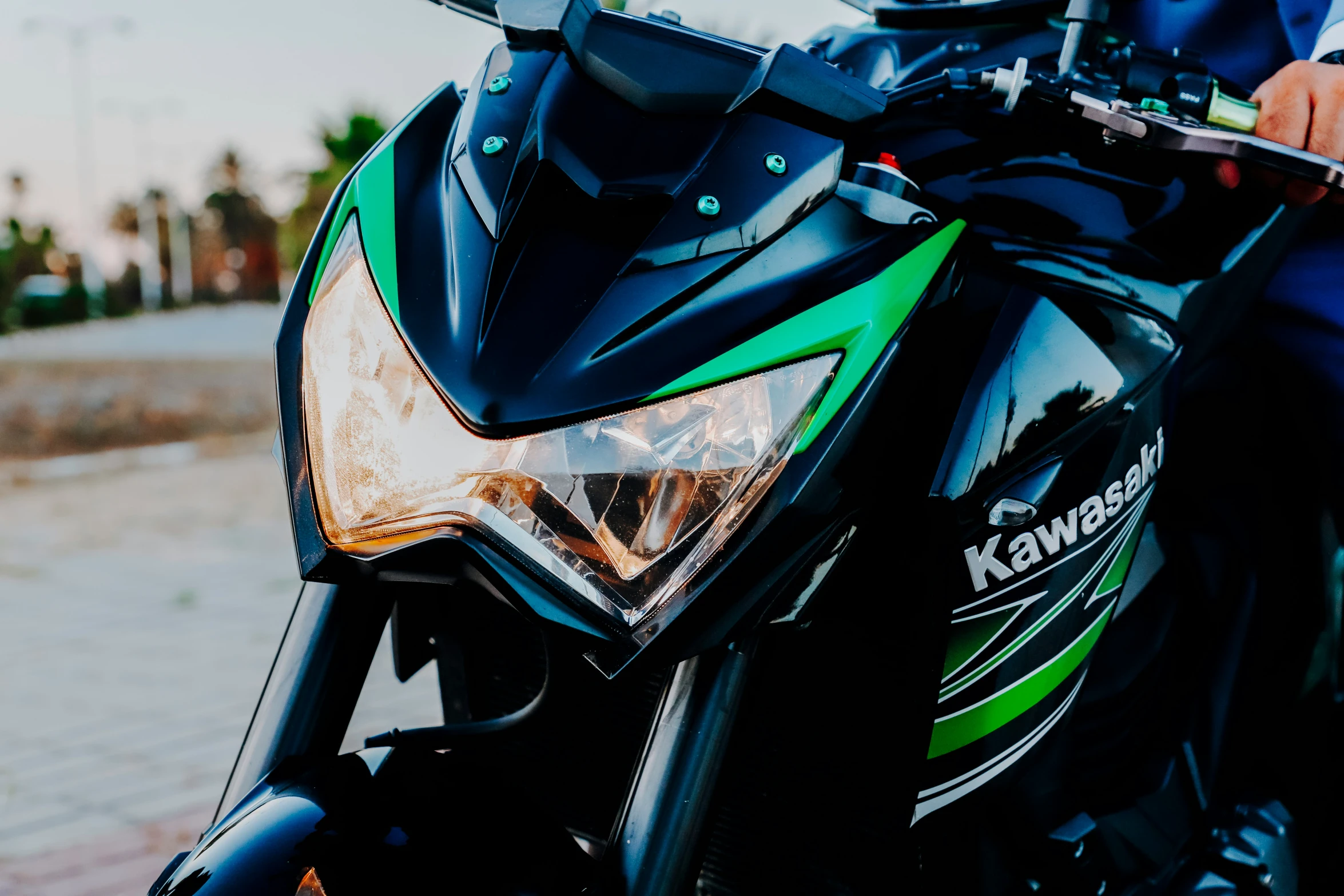 a person holding on to a motorcycle with a green and black frame