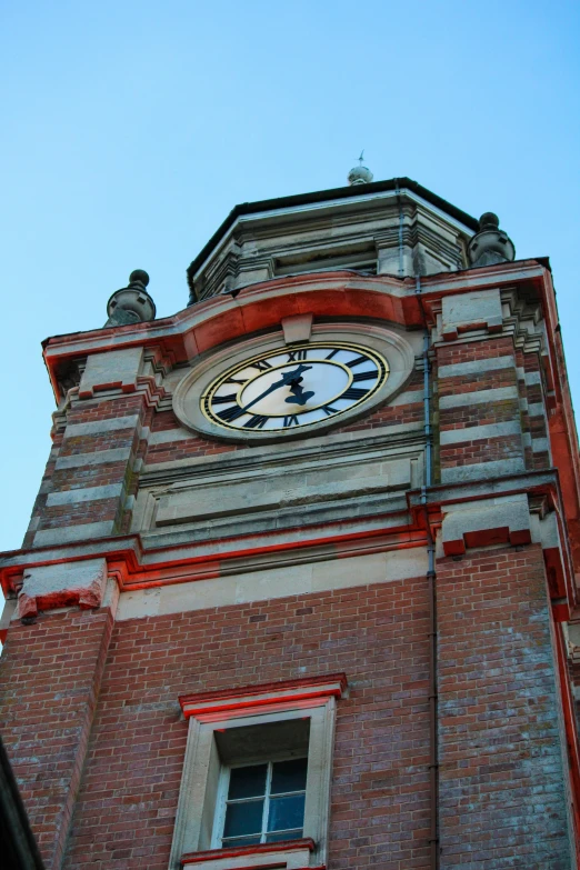 a very big clock tower with the sky in the background