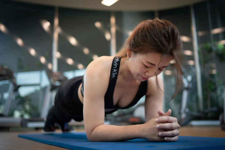 a woman is doing yoga with her hands clasped