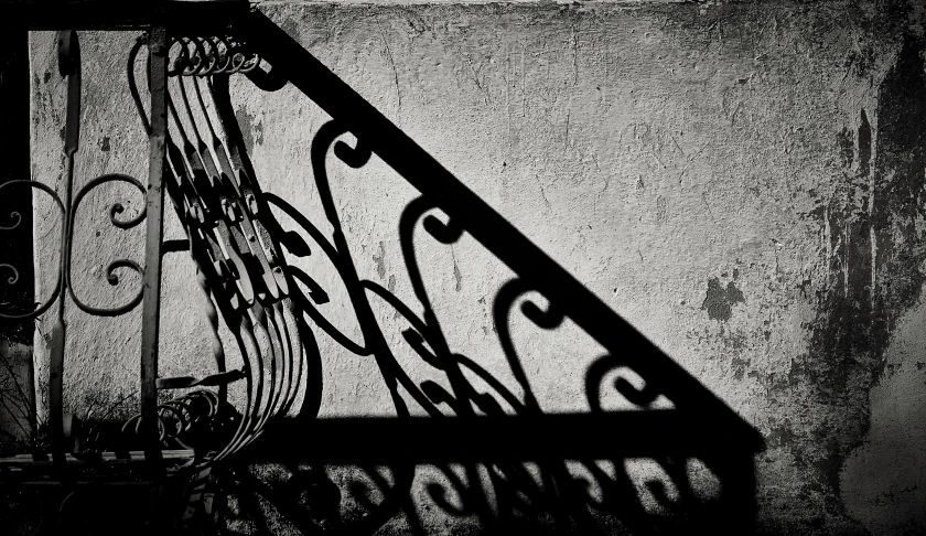 some stairs and railings casting a shadow on it