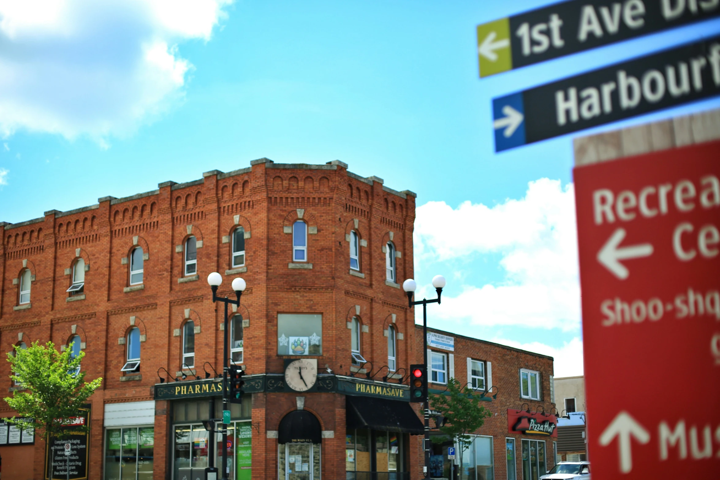 a large building on a corner near many street signs