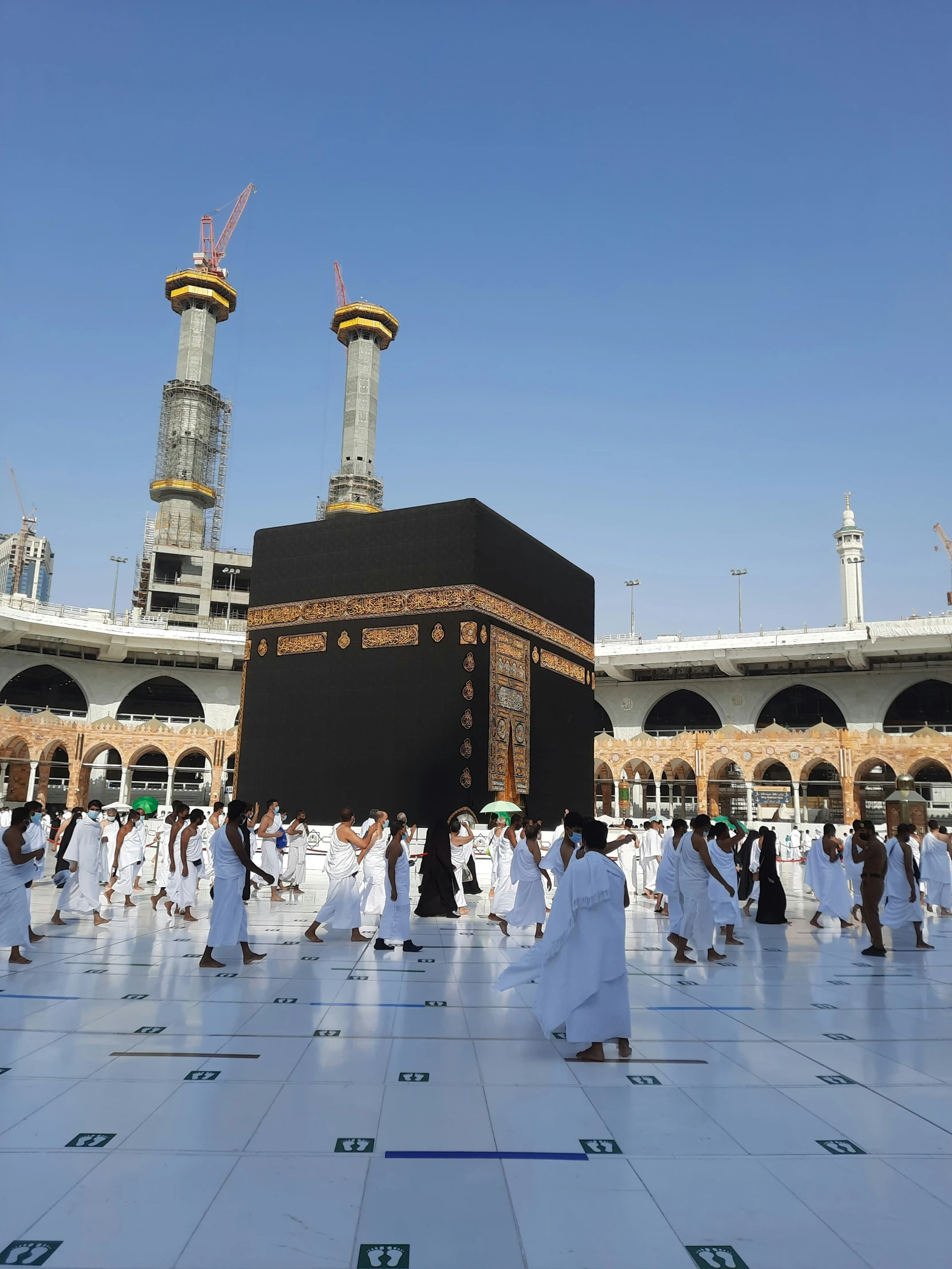 some people standing around an arabic shrine