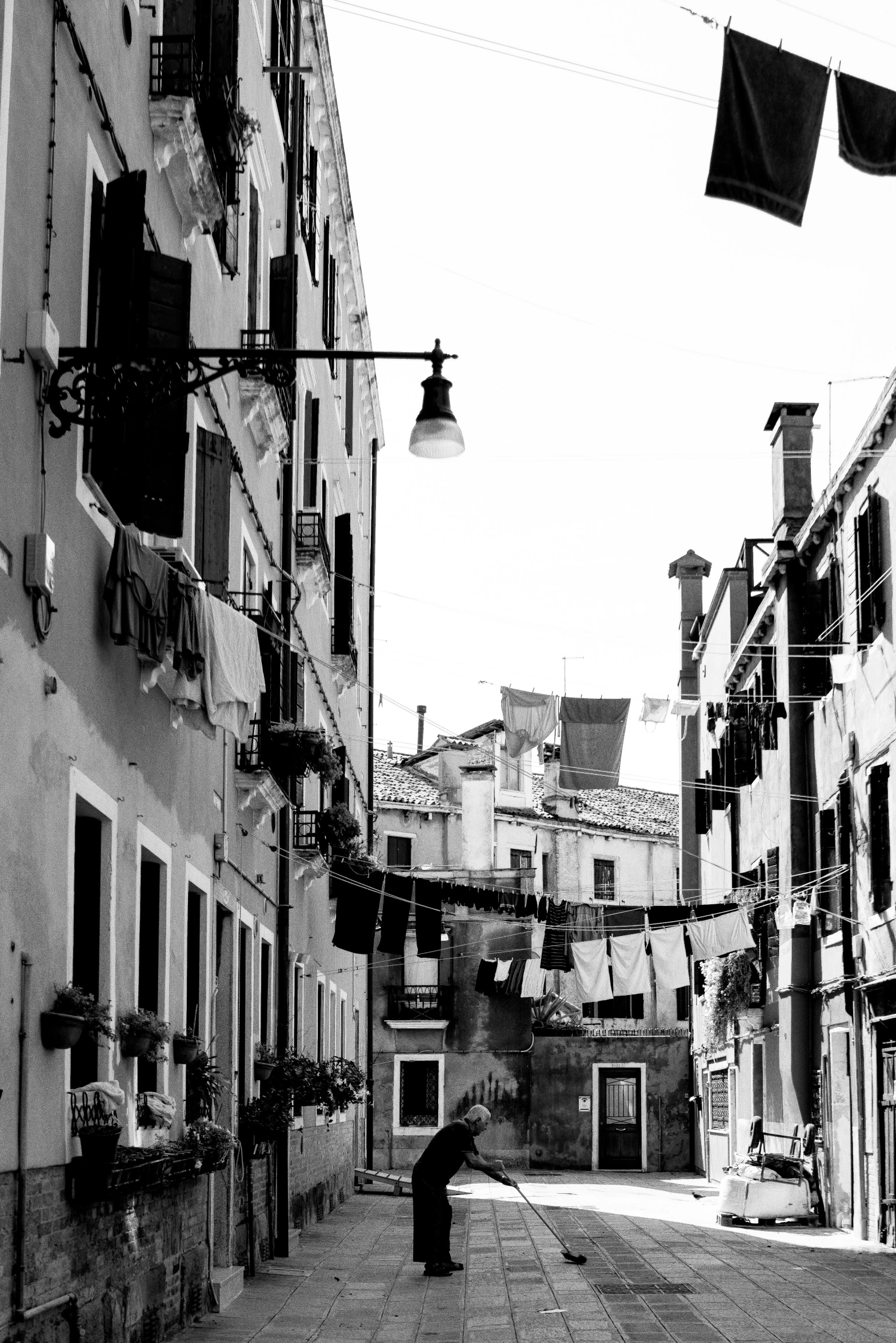 a black and white po of a man standing in an alleyway