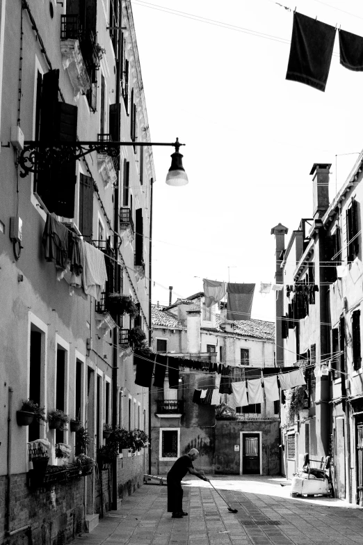 a black and white po of a man standing in an alleyway