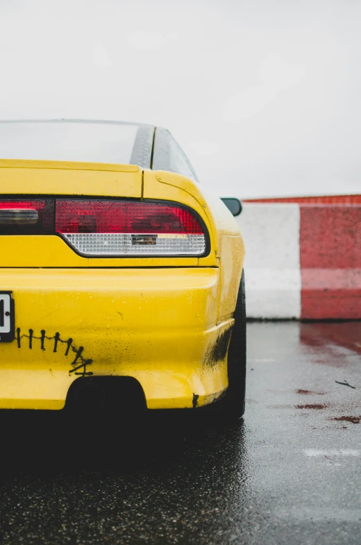 yellow race car in the rain