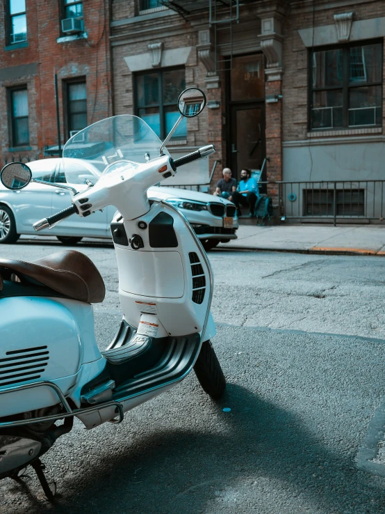 a motor scooter sitting in front of some buildings