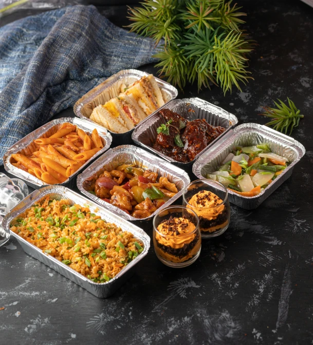 many different types of food in containers lined up