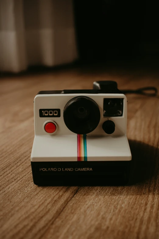 the camera is laying on top of a wooden table