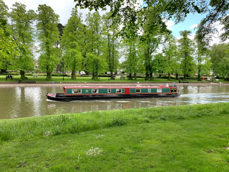 a large red and black boat in a river