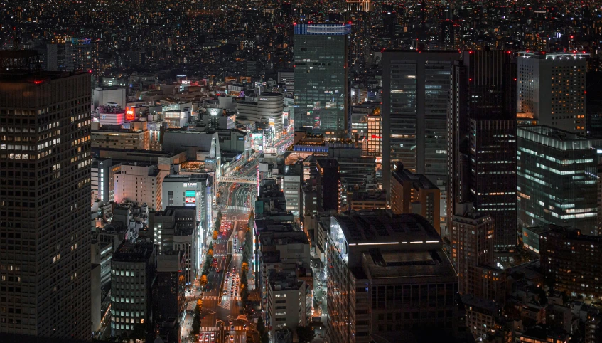 a view of buildings and traffic in a city at night