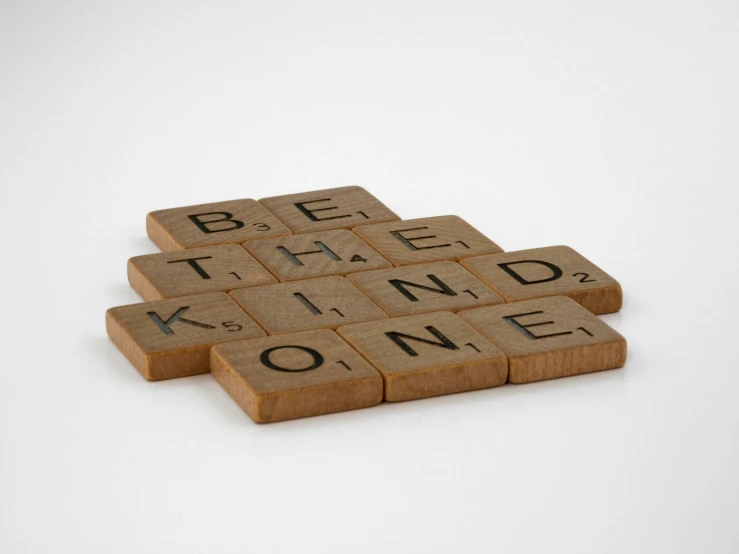 three scrabble tiles spelling be the kind of kind of home