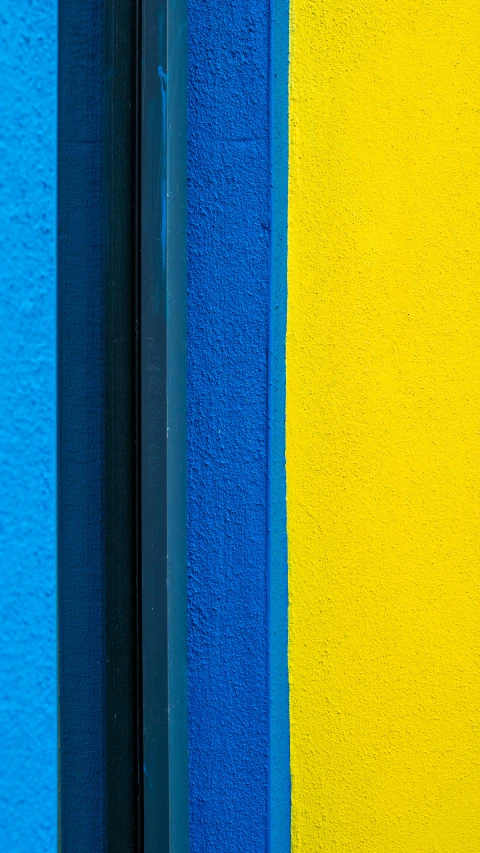 a yellow and blue wall is painted black