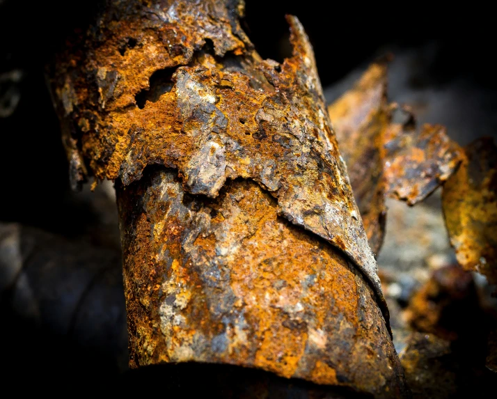 close up of rusted surface in dark background