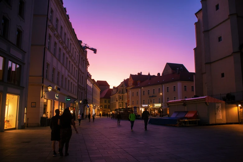 a row of buildings on a street next to a person walking