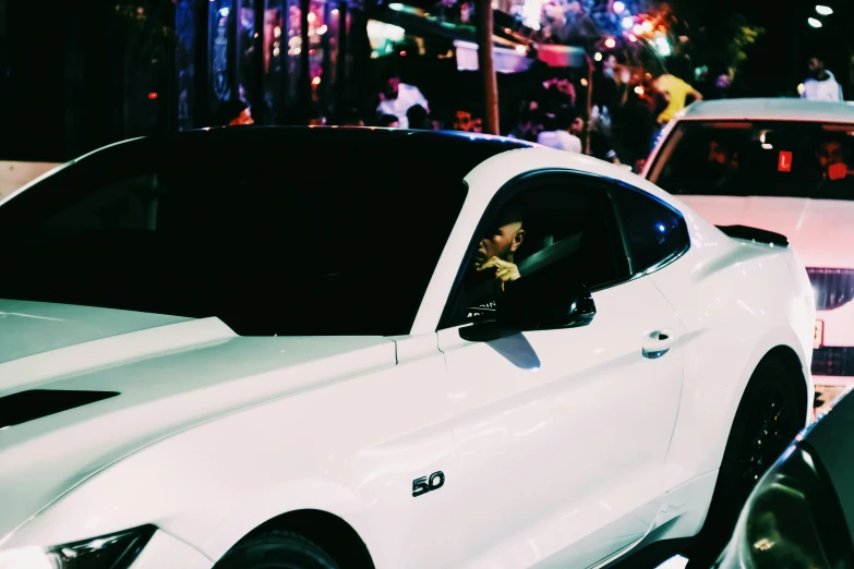 a white sports car sits parked in the street