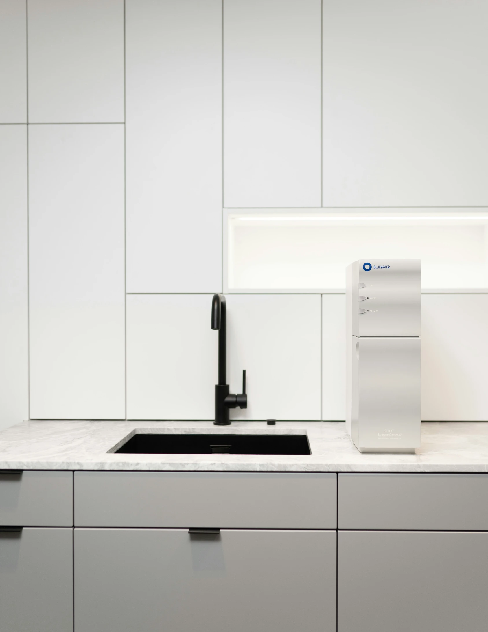 a modern, sleek kitchen with stainless steel and white cabinets