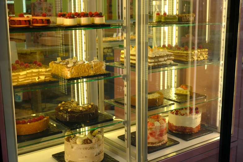 shelves filled with cakes and other desserts at a bakery