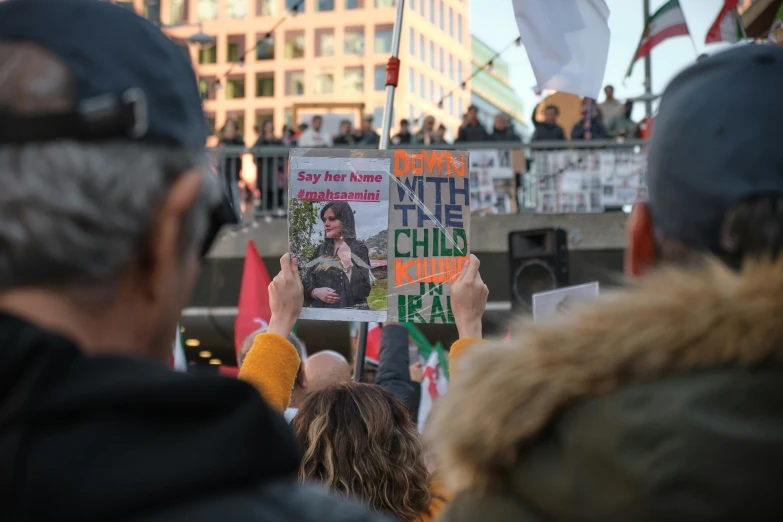 several people with signs that read vote and not drink tea