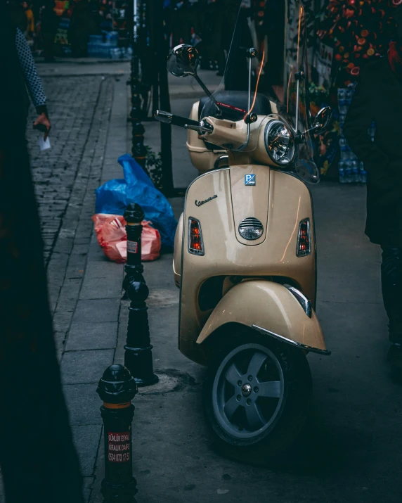 a vespa is parked outside a store on the sidewalk