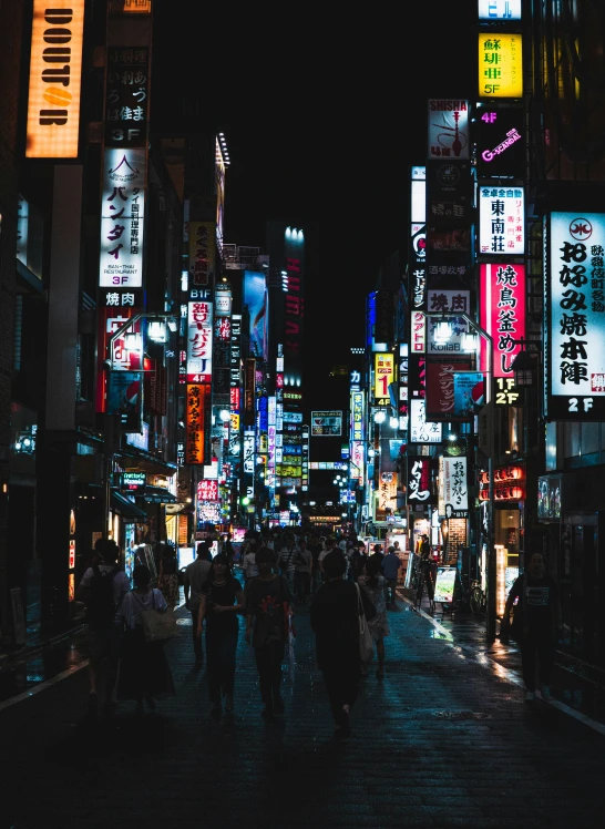 many people are walking down a busy street