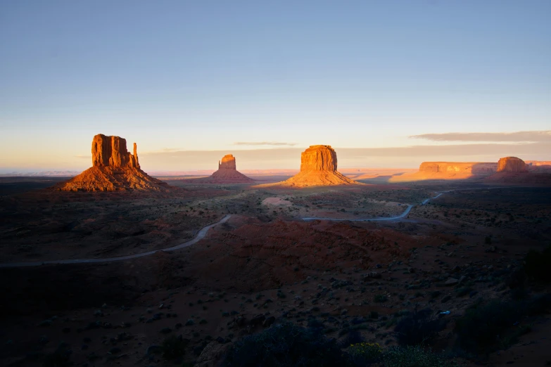 desert landscape with sunset in distance and large rock formations