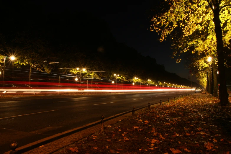 night s of street with lights and cars coming by