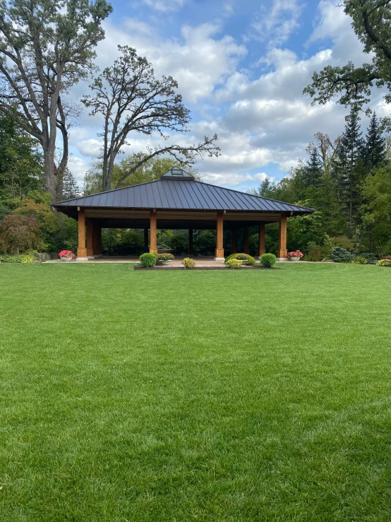 a gazebo in the middle of a grassy field