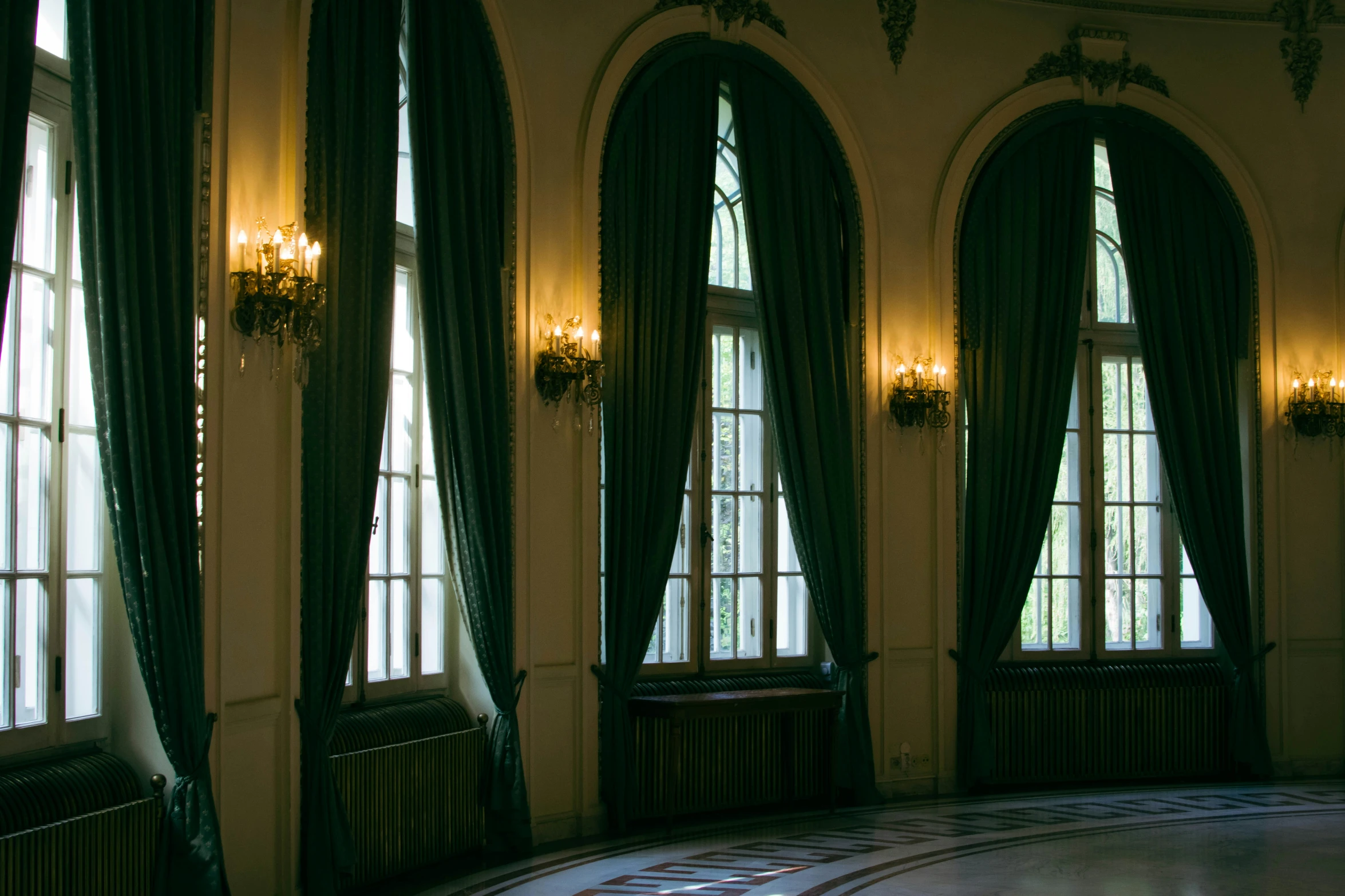 this is a room with three windows and a tiled floor