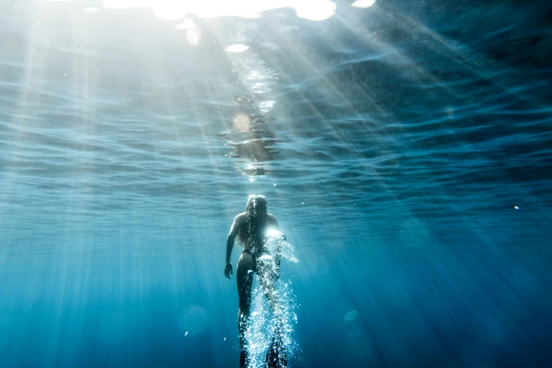 a man on a surfboard is swimming in the water