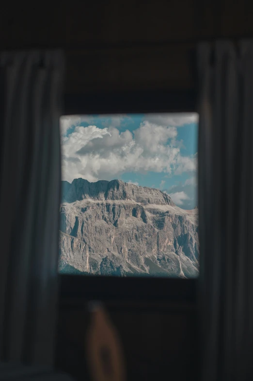 view from inside a bus showing mountains in the distance