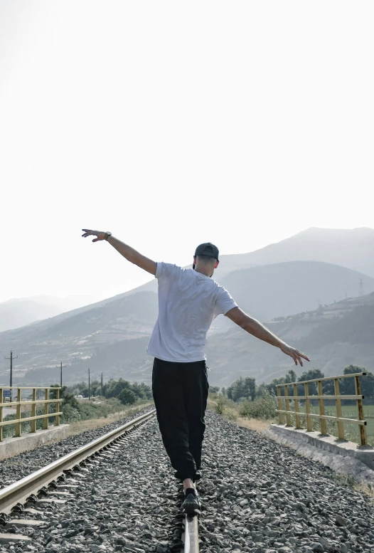 a person is doing some tricks on some train tracks