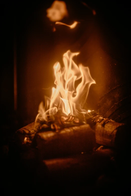 a fireplace with lots of fire and flames inside of it