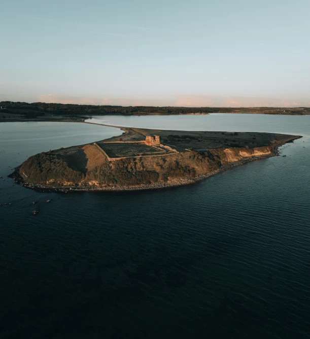 a small island with lots of water in the middle of a body of water