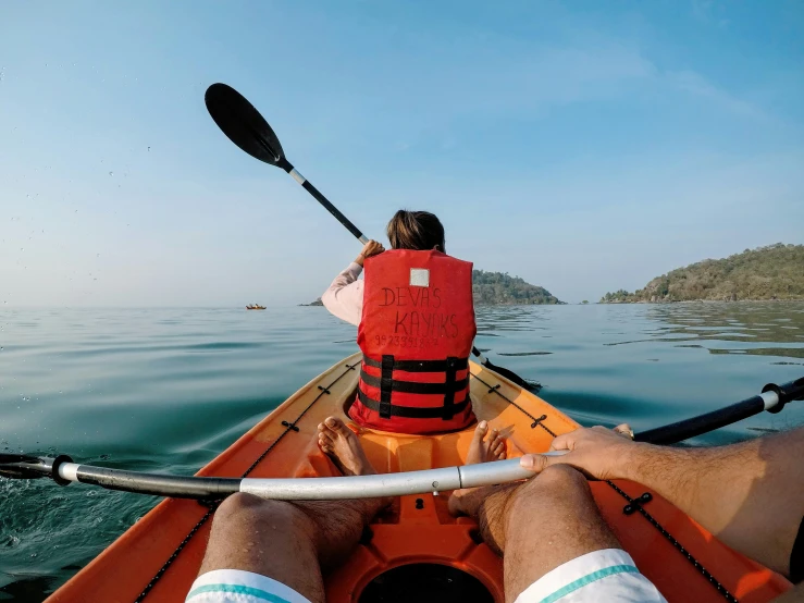 a man and woman in a canoe are floating on the water