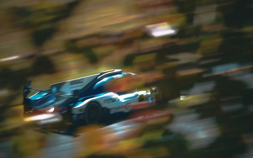 the car is racing down the track in the motion blurry po