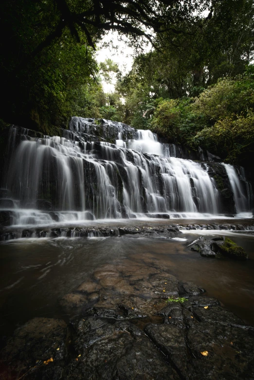 the small waterfall is flowing down a mountain