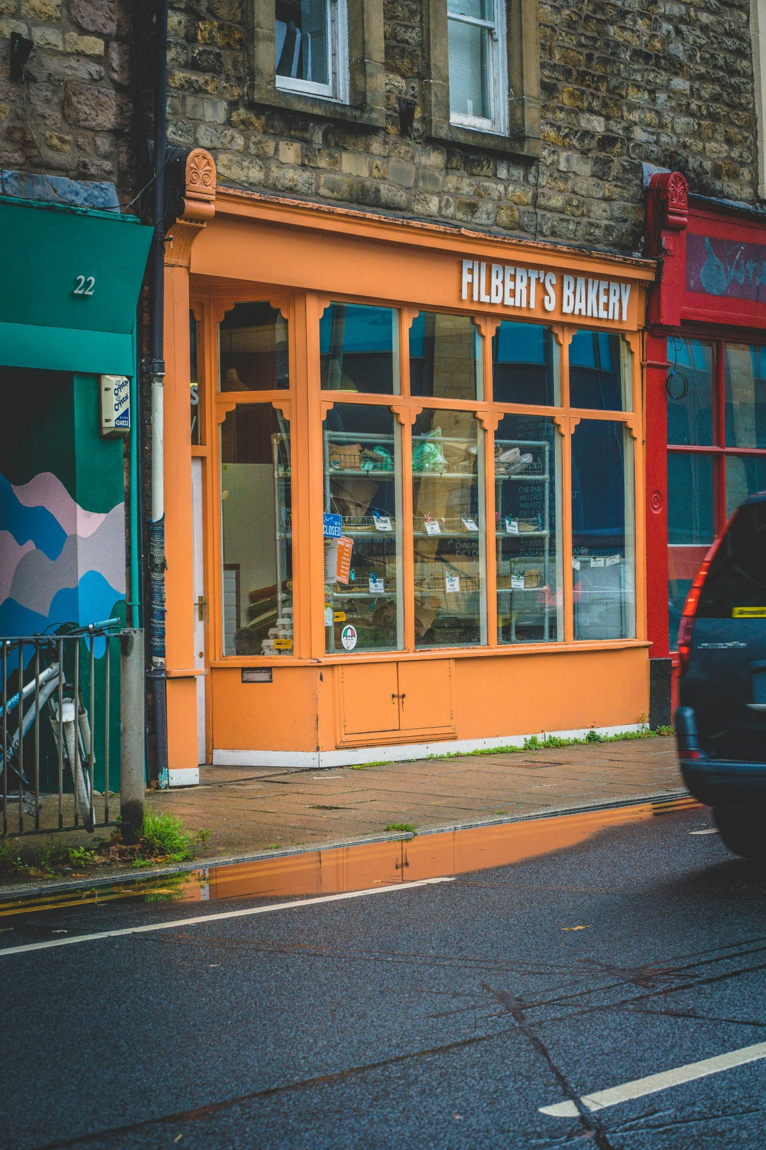 the shop has a small car parked outside