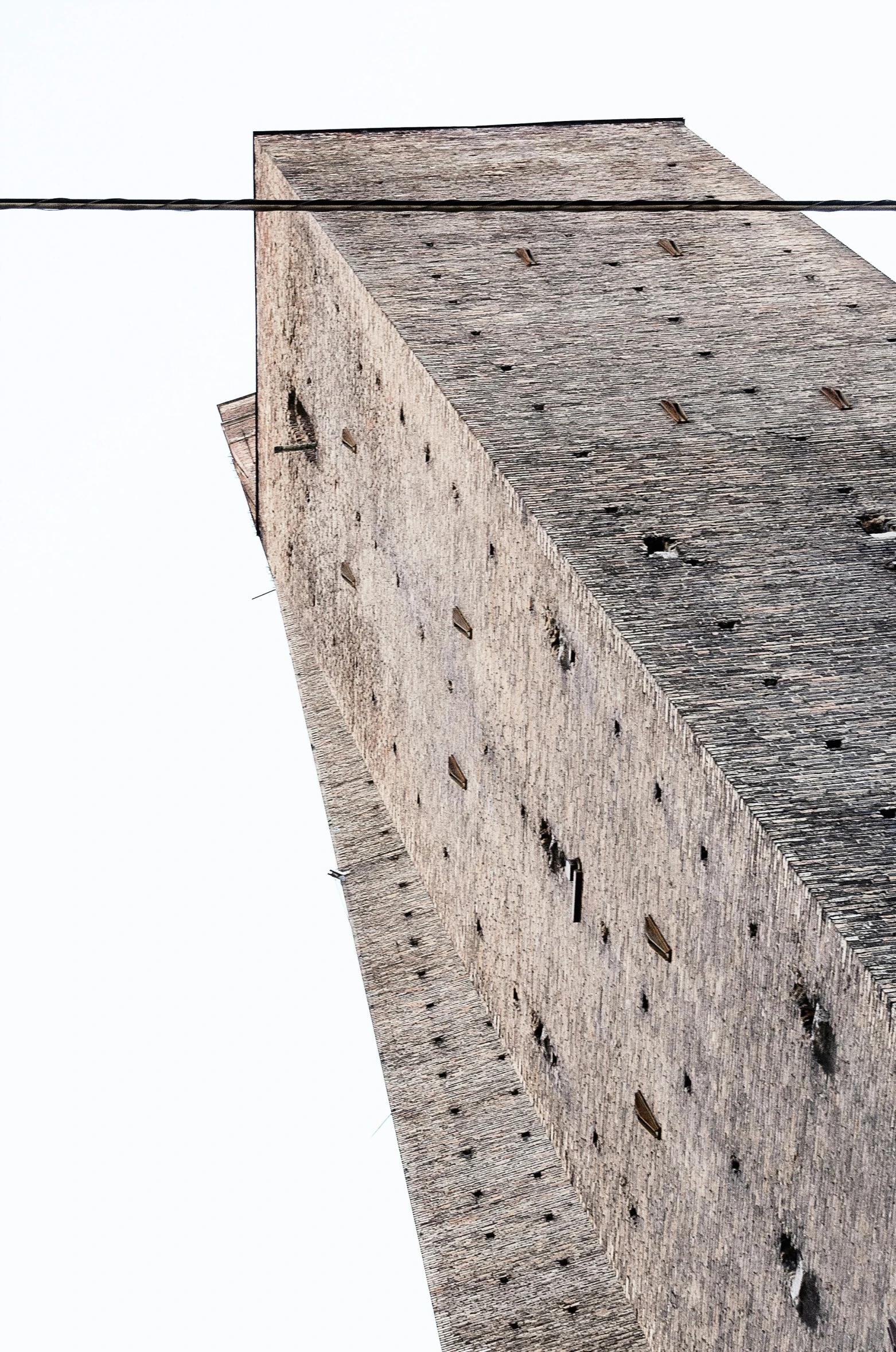 an old cement building with a bird on top