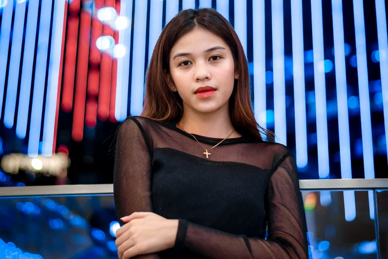 a woman in a sheer black dress posing