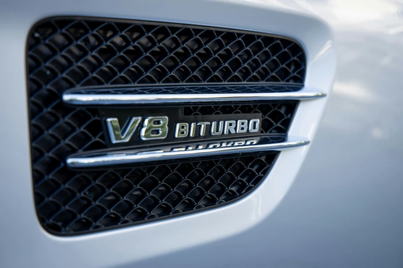 a close up of the emblem on the grille of a silver vehicle