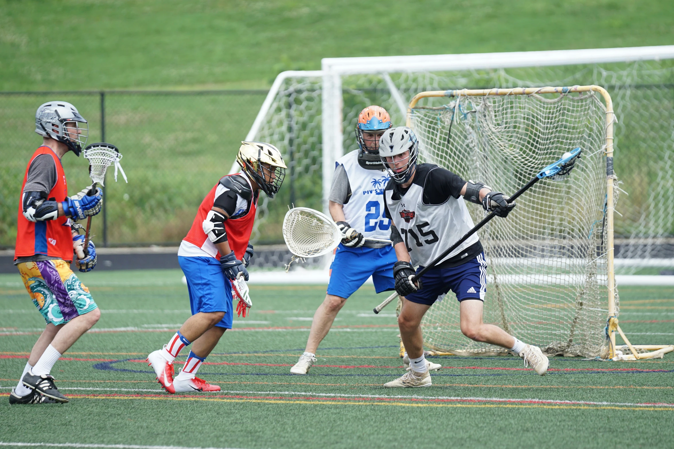 the young men are playing lacrosse together