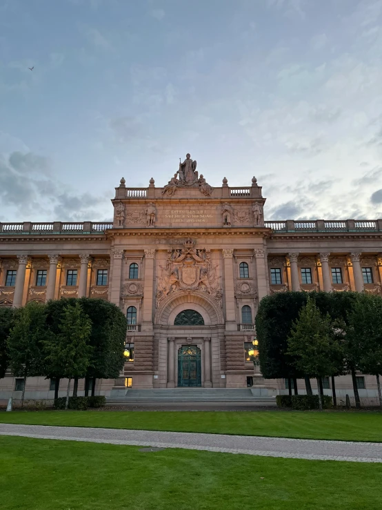 a large stone building with green grass around it