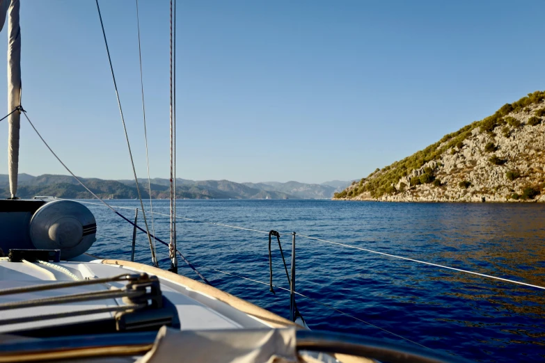 a boat on the water near a small hill