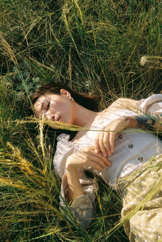 woman sleeping in the grass with her eyes closed