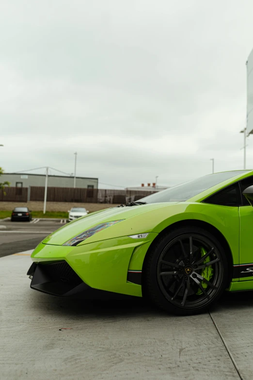 a green sports car parked on the side of a street