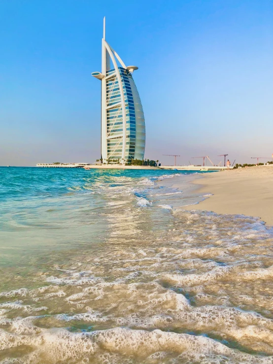 burjq in the middle of the sea next to a beach