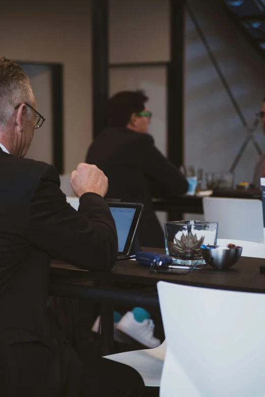 a man at a meeting raises his fist