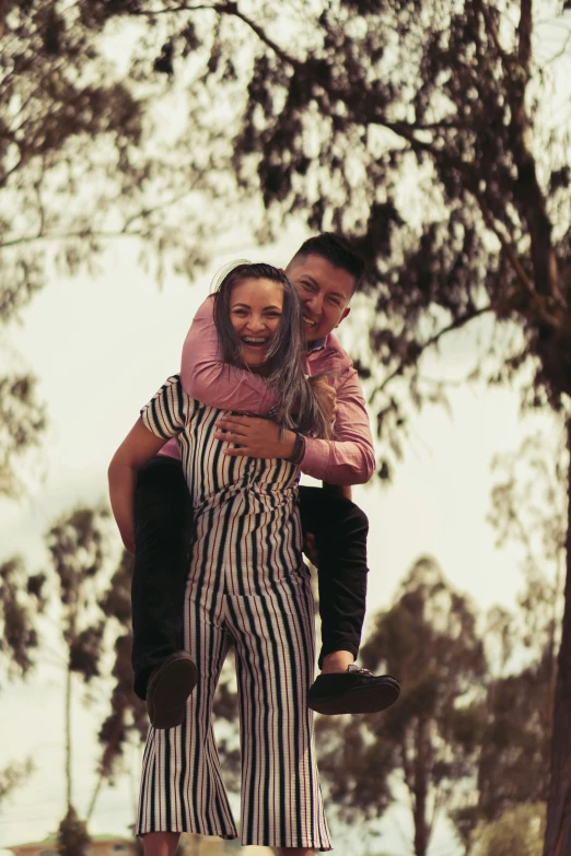 a man and woman ride a skateboard while holding a little girl